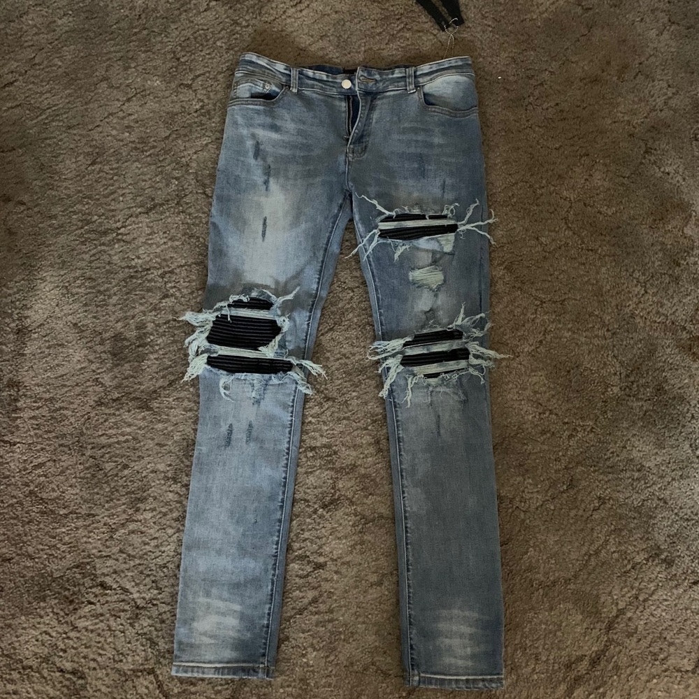 Light Blue Amiri Jeans with leather details.